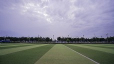 蓝天白云草地蓝天下的足球场摄影